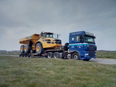 A Stevens Equipment Rental Volvo A45 dump truck on a low loader